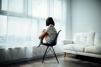 Supportive portrait of a person in a bright, candid setting